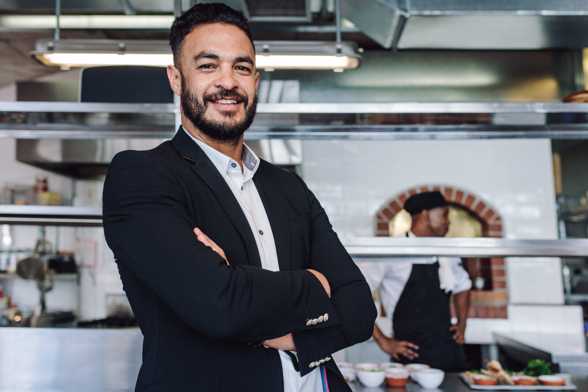 Young businessman standing in his restaurant